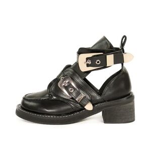 Black boot with gold-toned buckles.
